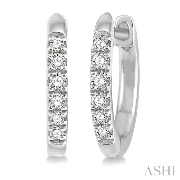 1/8 ctw Round Cut Diamond Huggie Earrings in 10K White Gold